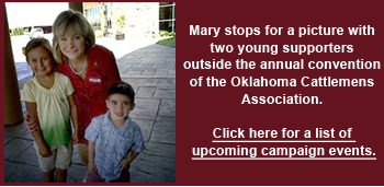 Mary takes a picture with two young  supporters outside the annual convention  of the Oklahoma Cattlemens Association.